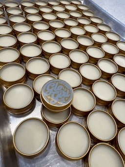 Glo Girl tins being hand-filled in the Austin studio.